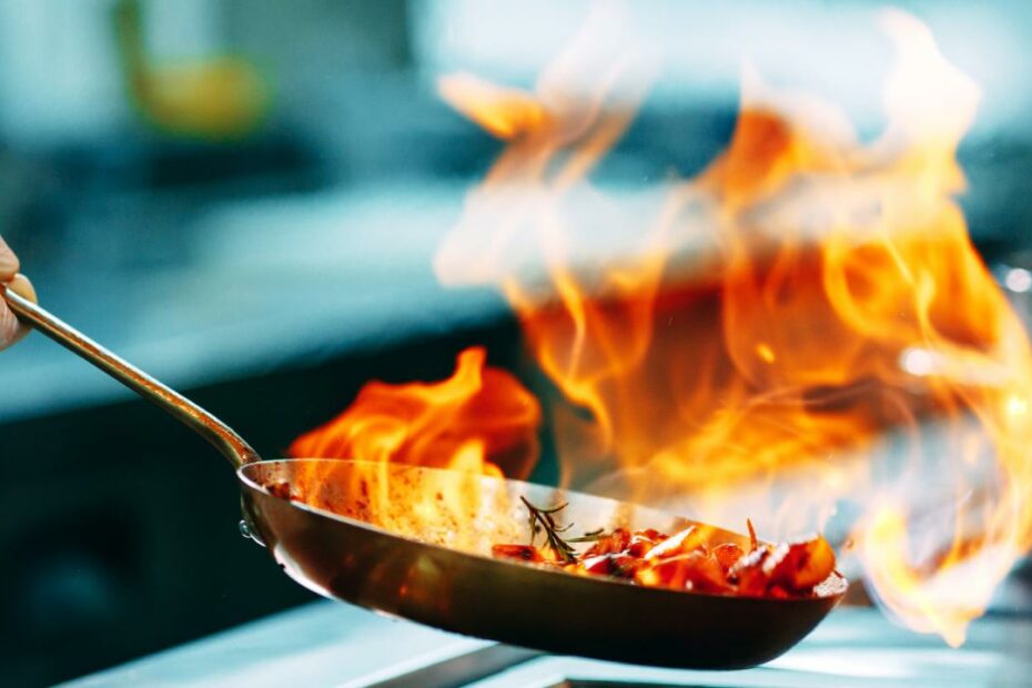 The Real Reason Restaurant Pans Sometimes Catch On Fire